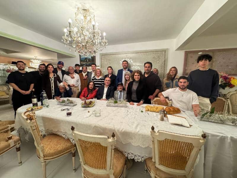a group photo of the hosts and all the guests